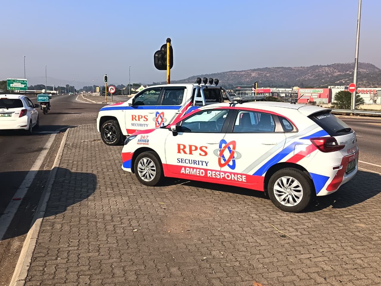 Two RPS Security armed response vehicles parked on a Rustenburg roadside